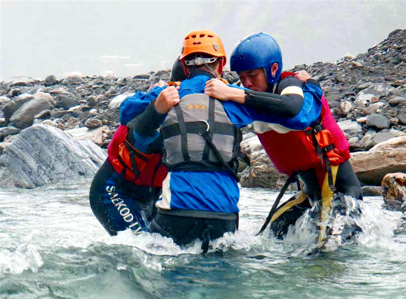 When crossing the river in a group of 3 or more persons, , people may hold one another by the arms to form a circle and then proceed in rotation.