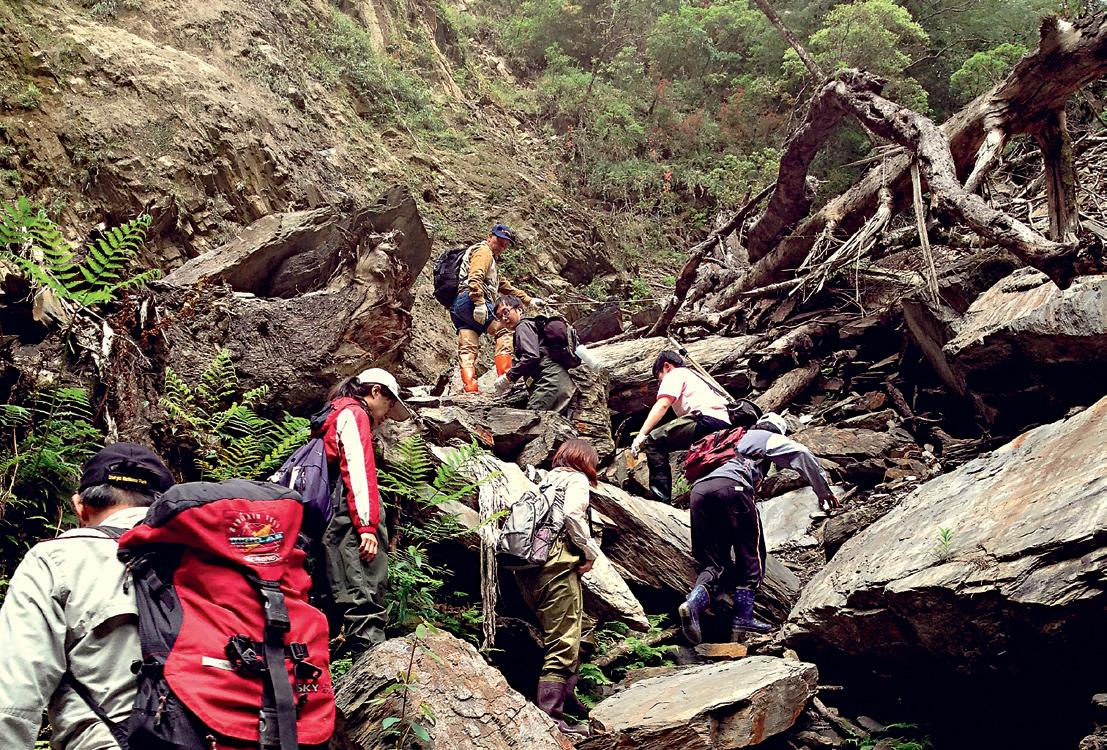 Research personnel hiking while conducting a survey.