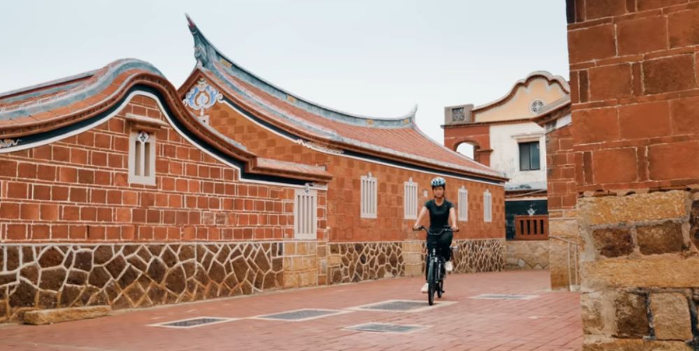 小靜騎自行車穿梭在百年老宅巷弄中 (金門公園管理處提供) 