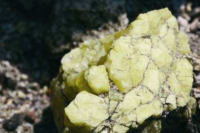 The sulfur gas erupts from the opening, sublimates on the rock surface and becomes fragile crystal nuggets