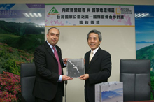 Director Lin presented Mr. Himatsinghani with a book during the ceremony